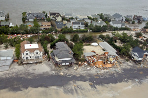 Coastal houses damaged by storm, aerial view.