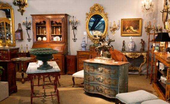 Antique furniture and decor in showroom.
