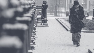 Person walking on snowy city street.